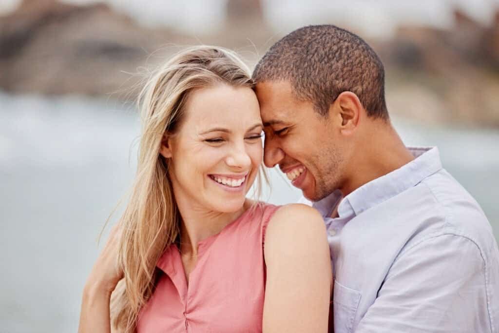 The Power of Fenugreek: Transform Your Testosterone Levels and Libido 5 Happy couple embracing and smiling, sharing a tender moment outdoors by the beach.