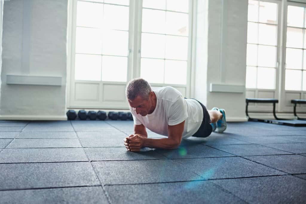 Can Zinc Increase Testosterone? Unlock Your Potential Naturally 5 As we age and looking for every edge we can get while we workout, we wonder can zinc increase testosterone. As older man completes a plank with ease on gym mats.