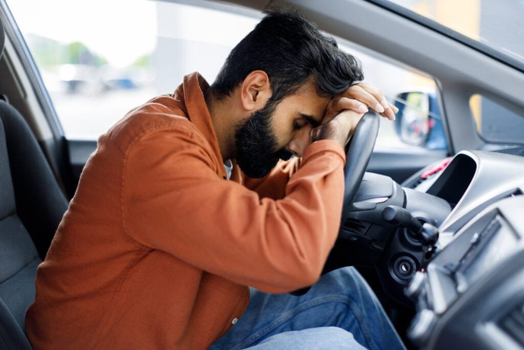 Ashwagandha: A Natural Solution for Men's Anxiety and Stress 3 Young Man stressed in his car looking tired. Is Ashwagandha a natural answer?