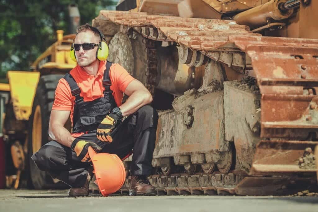 Maca Root for Men: How to Supercharge Your Stamina Naturally 11 Man tired from the grind next to heavy tractor - Could supplementing with MACA be his answer?