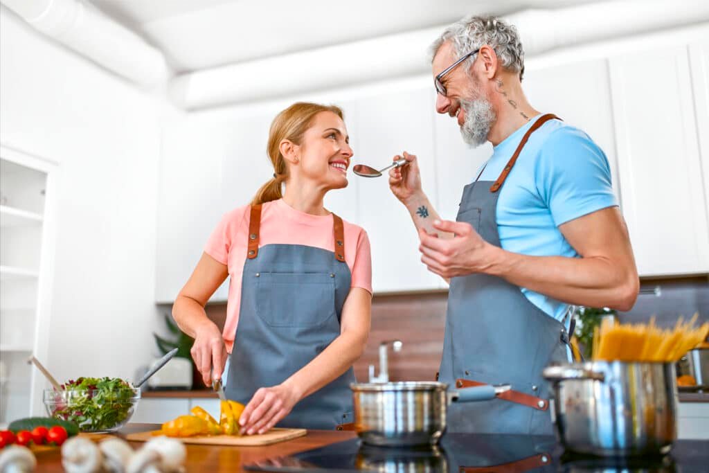 a man and woman cook happily in kitchen - is black pepper more than just a spice?