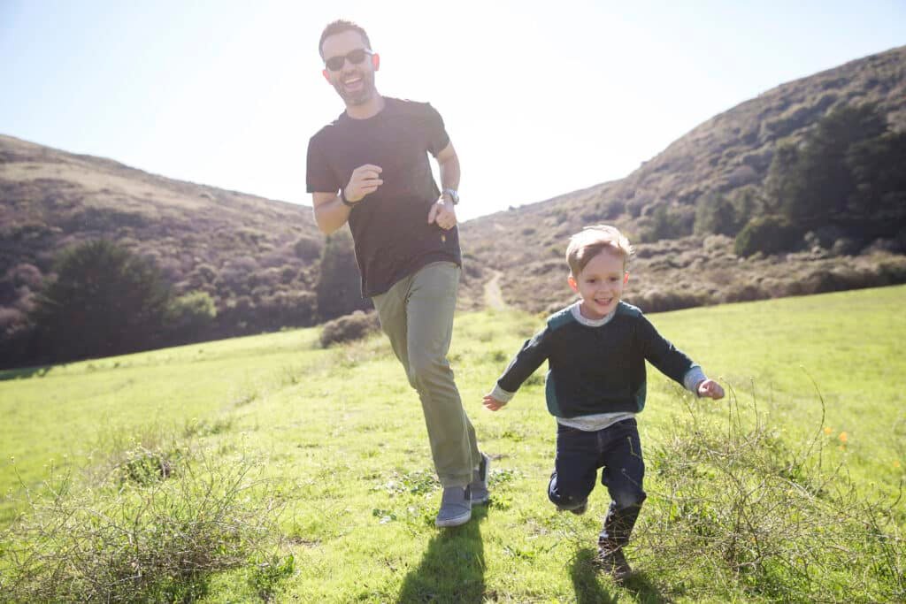 Niagen Benefits: Boosting Health at the Cellular Level 19 Young father and son running in a field as he supplements with Niagen Benefts.