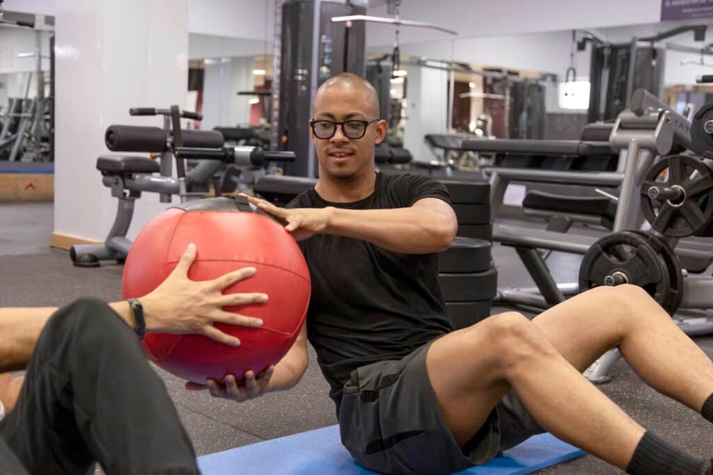 Best Ashwagandha for Testosterone: What Matters Most 17 Man exercising with medicine ball due to taking best ashwagandha for testosterone