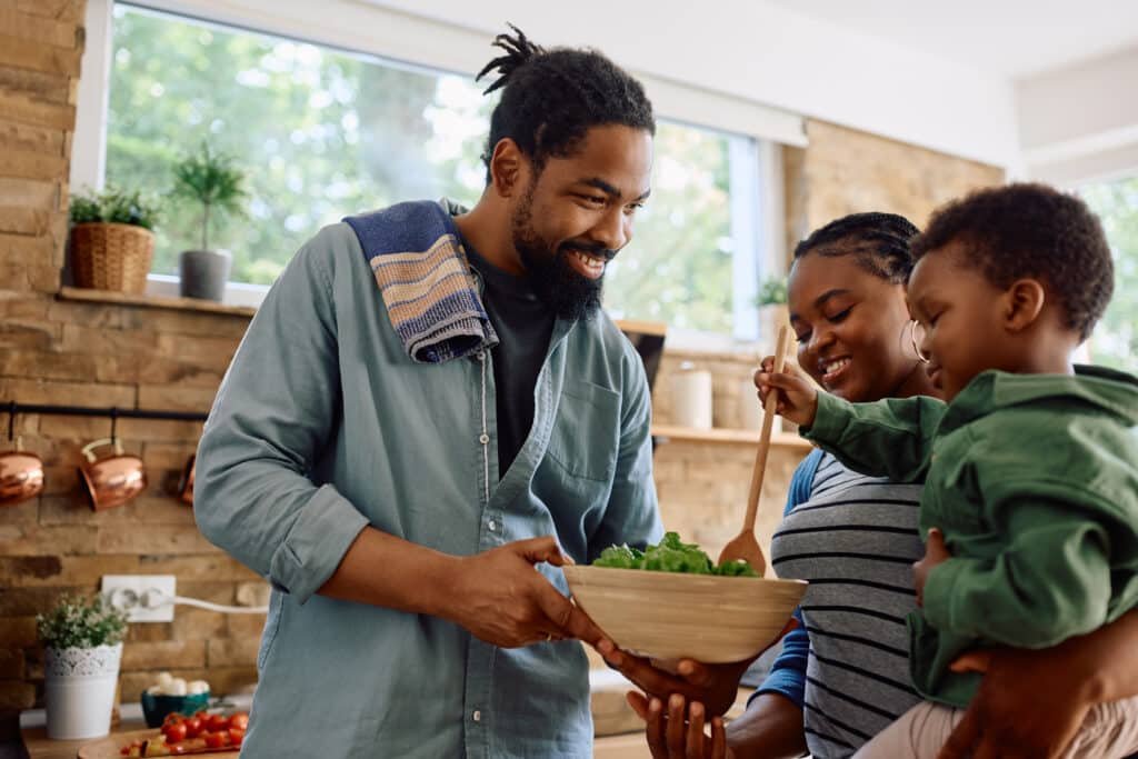 Vegan Amino Acid Supplements: Facts Nobody Tells Busy Dads 7 Happy black family preparing meal together in the kitchen thinking about vegan amino acid supplements