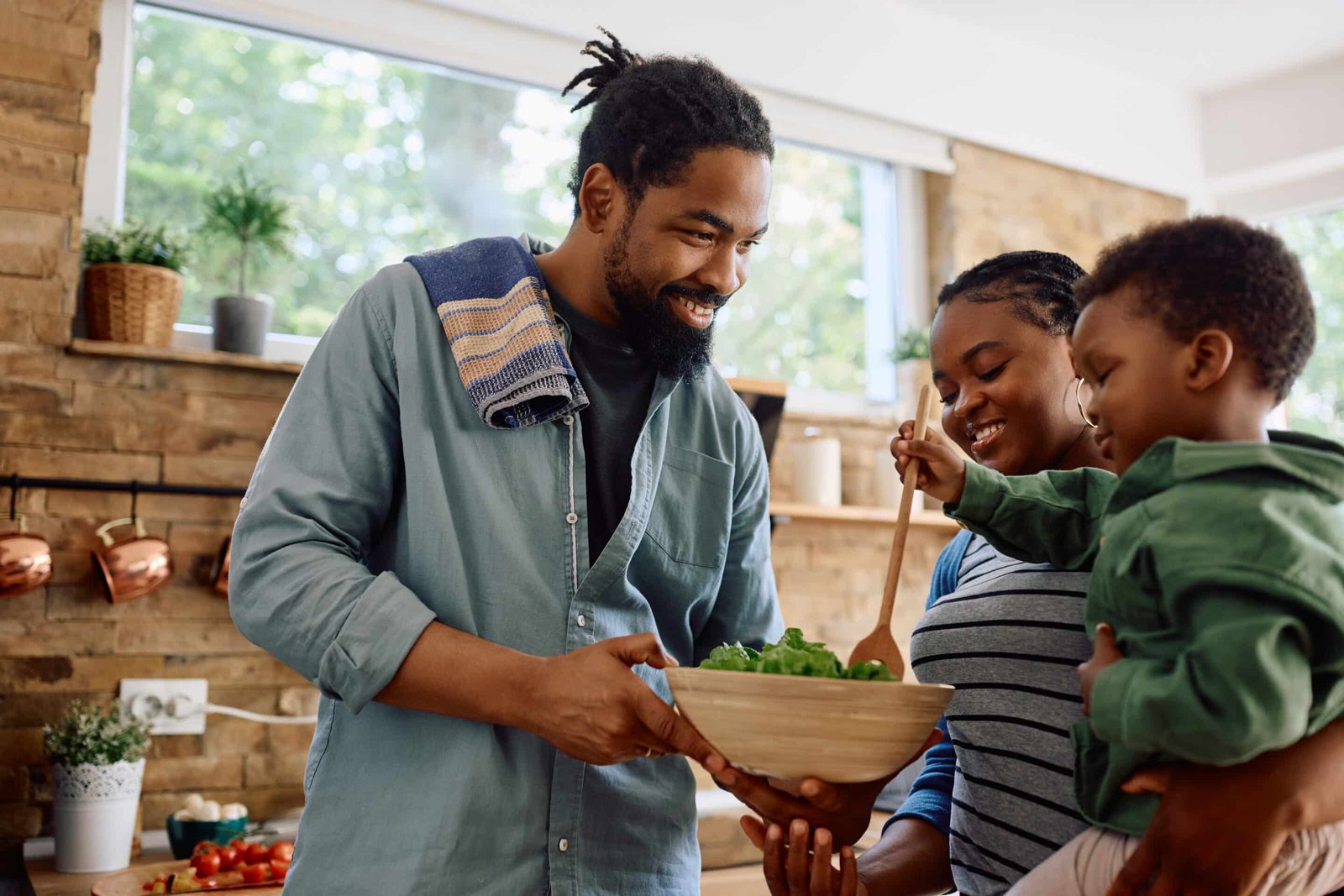 Happy black family preparing meal together in the kitchen thinking about vegan amino acid supplements