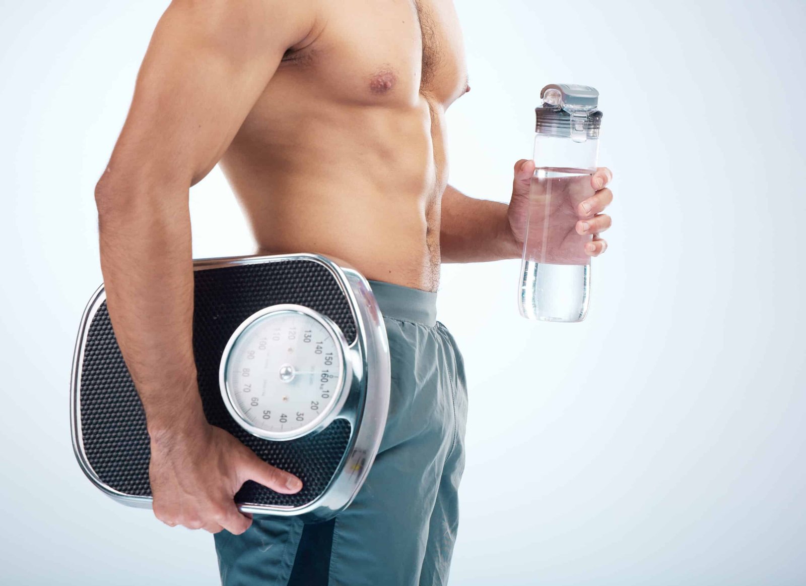 a man holding a scale and a water bottle. Diet for High Cortisol article