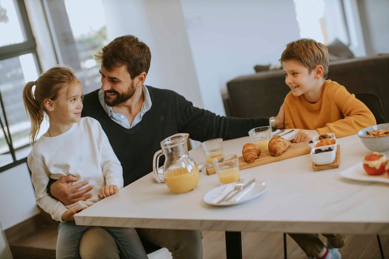 Dad having breakfast with son and daughter after having good sleep health and waking up refreshed.